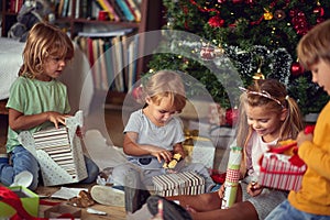 Family at  Christmas. Children under Christmas tree with presents