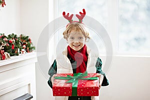 Family on Christmas day. Kids with gifts at door