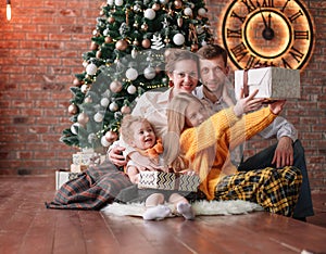 Family with Christmas gifts in a cozy living room