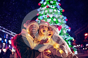 Family, christmas, holidays, season and people concept - happy family over city background and snow