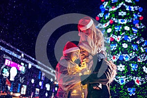 Family, christmas, holidays, season and people concept - happy family over city background and snow