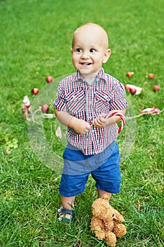 Family Christmas in July. Portrait of little boy near christmas tree. Baby decorating pine. Winter holidays and people concept.