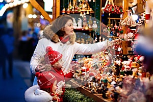 Family at Christmas market. Xmas winter fair.