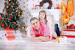 Family, christmas, x-mas, happiness and people concept - smiling father and daughter holding gift box