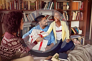 Family on Christmas morning opening presents and enjoying their