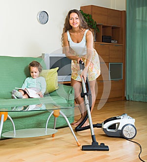 Family cleaning home with vacuum cleaner