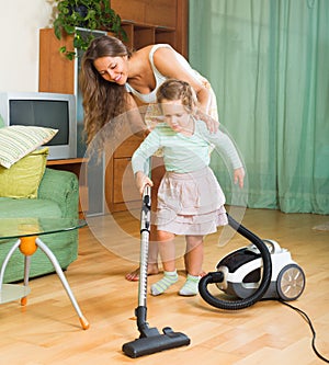 Family cleaning home with vacuum cleaner