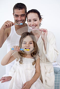 Family cleaning their teeth in bathroom