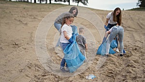 Family cleaning up plastic trash. People are eliminating environmental problem. People at garbage dump. Family cleaning