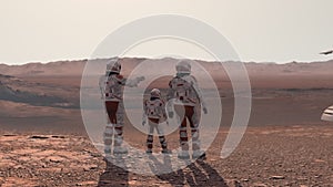 Family colonists immigrants to Mars, a man, a woman and a child admire the Martian landscape, the city and the spaceship