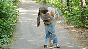 Family concept. Cute baby girl runs to Mom`s embrace in the park