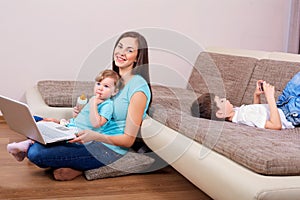 Family concept. Happy family with laptop,phone on the floor in t