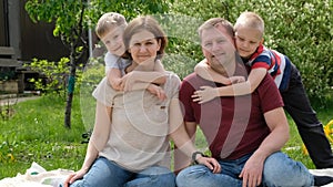 Family concept shot - woman and man and their children boys enjoy sunny day outdoors