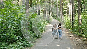 Family concept. Young happy mother hugging her daughter in the park