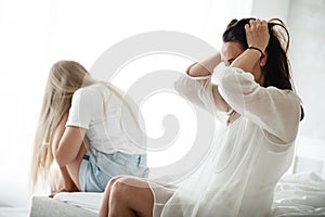 Family conflict and relations concept. Mother and daughter having quarrel and aguring at home. Sad woman and teenage