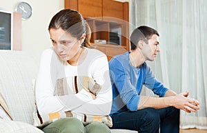 Family conflict. Sadness woman against unhappy man