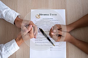 Family conflicts and love problems concept. The hands of the husband and wife with the divorce paper