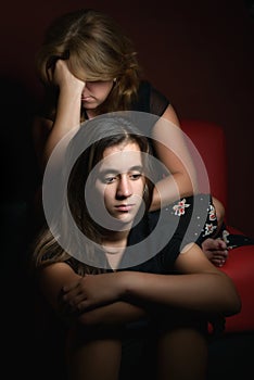 Family conflicts - Sad teenage girl and her worried mother photo