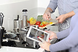 Family is cooking a dinner / vegetables with meat together photo