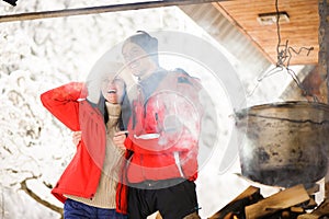 Family cooking dinner in the winter outdoors. Bonfire, barbecue, bowler.