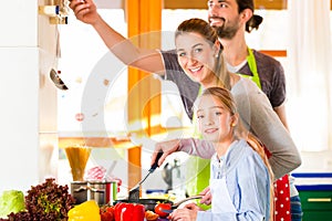 Family cooking in domestic kitchen healthy food