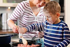 Family cooking in kitchen