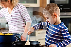 Family cooking in kitchen photo