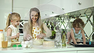 Family Cooking. Mother With Daughters Preparing Dough For Baking