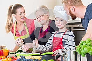 Family cooking in multigenerational household with son, mother,