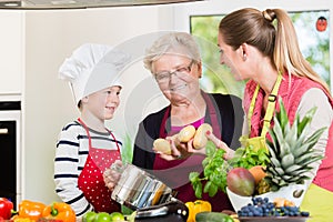 Family cooking in multigenerational household with son, mother,