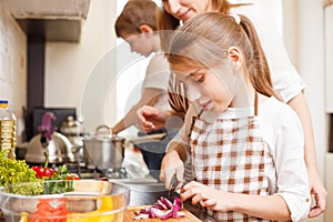 Family cooking. Mum and children in the kitchen