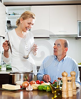 Family cooking Spaniard tomatoes at home