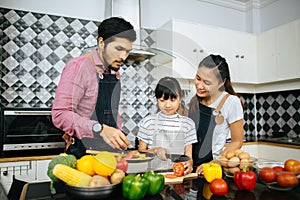 Family cooking time : Happy family help cooking meal together in kitchen