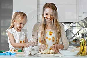 Family Cooking. Woman With Child Baking At Home