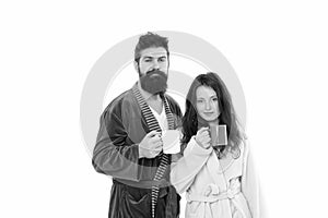 Family couple drink tea in bathrobe. couple in love. good morning coffee. man and woman drinking milk from cup. bearded