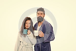 family couple drink tea in bathrobe. couple in love. good morning coffee. man and woman drinking milk from cup. bearded