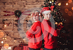 Family couple on holiday in living room decorated by Christmas tree and present gift boxes. Portrait loving family close up