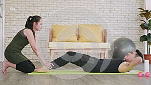 Family couple husband and wife healthy trainer workout home in the living room