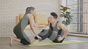 Family couple husband and wife healthy trainer workout home in the living room