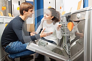 Family couple looking at dishwashers