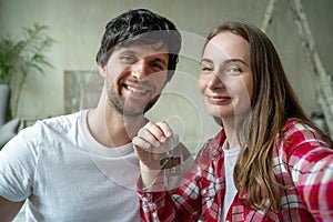 Family couple proudly shows off the keys to their new home