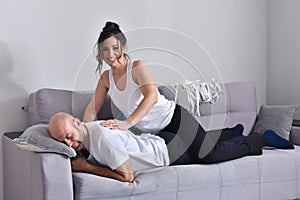 Family couple smiling ans hugging sitting on sofa