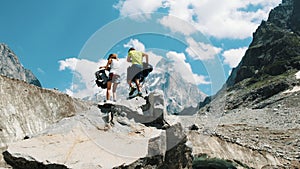 Family couple of tourists with backpacks in the hike to remove rucksacks on the top in the mountains.