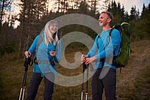 Family couple of travelers hiking in the mountains.