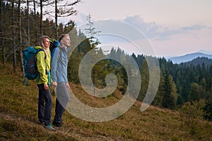 Family couple of travelers hiking in the mountains.