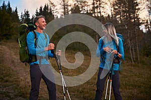 Family couple of travelers hiking in the mountains.