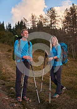 Family couple of travelers hiking in the mountains.