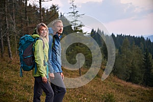 Family couple of travelers hiking in the mountains.