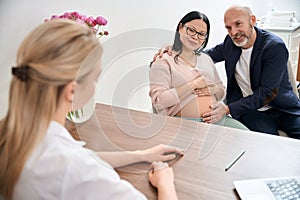 Family couple visiting obstetrician to talk about third trimester of pregnancy