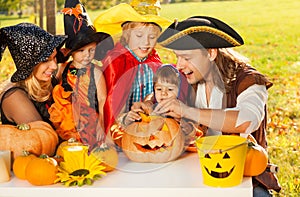 Family craft together Jack-O'-Lantern from pumpkin